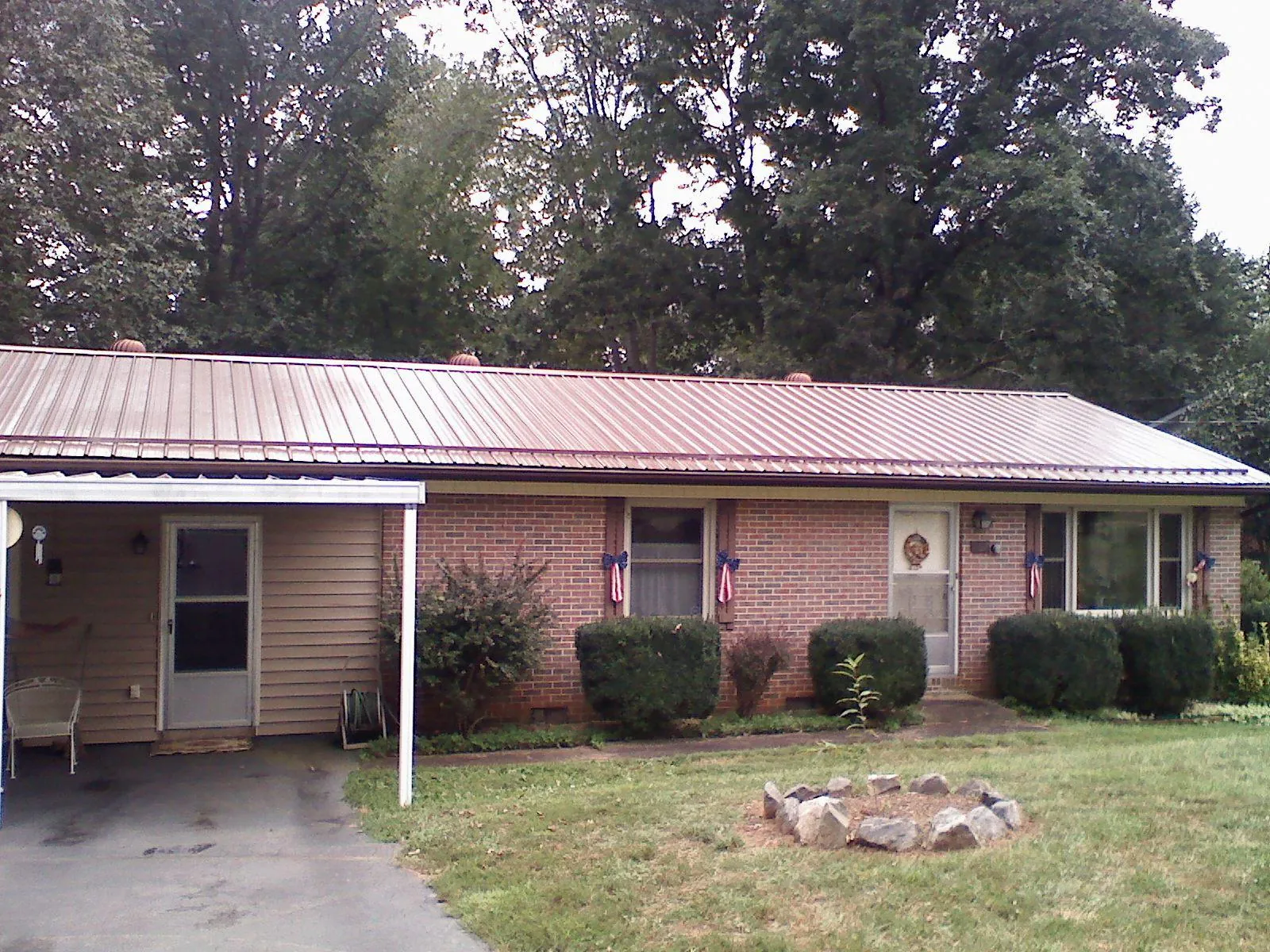 Bronze metal roof and carport on a brick ranch home — Roof Repair work by our crew in Brookside