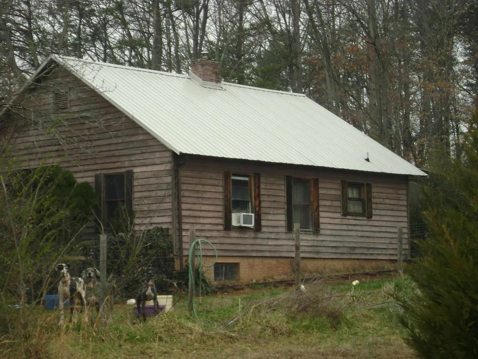 White metal roof on an old wood sided farmhouse, from a Asphalt Shingle Roof Repair job in Brookside